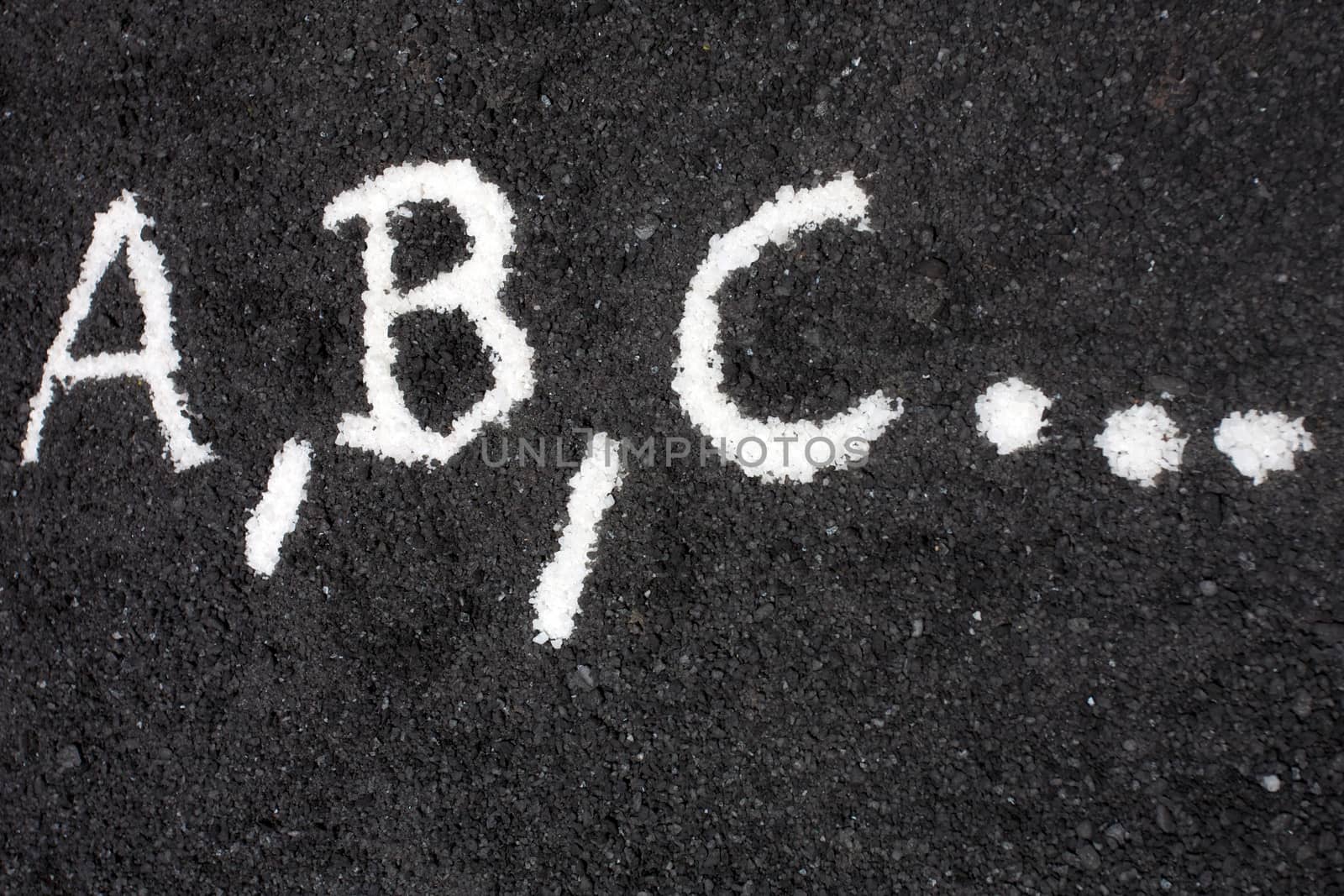 White letters a, b, c, written on the floor by watchtheworld