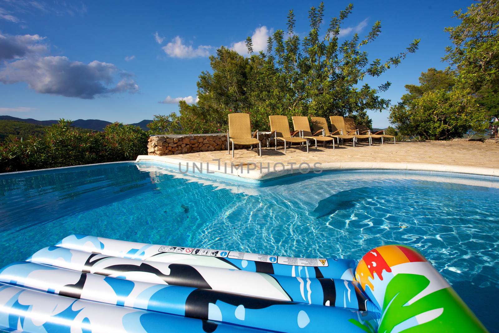 Air bed floating on a swimming pool by watchtheworld