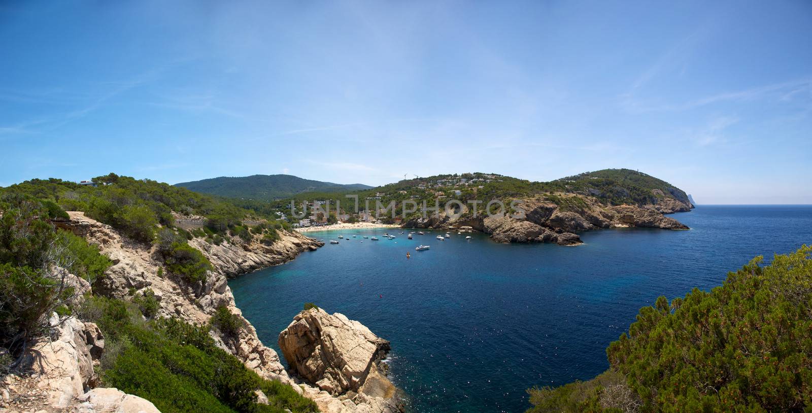 Ibiza mediterranean coast line with sun and blue sky