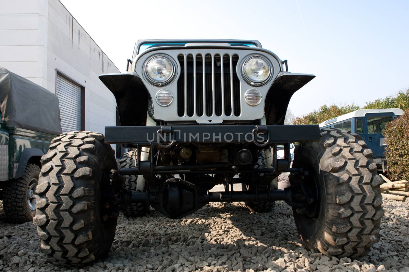 Front end, headlights and grille on a vintage four-wheel drive vehicle.