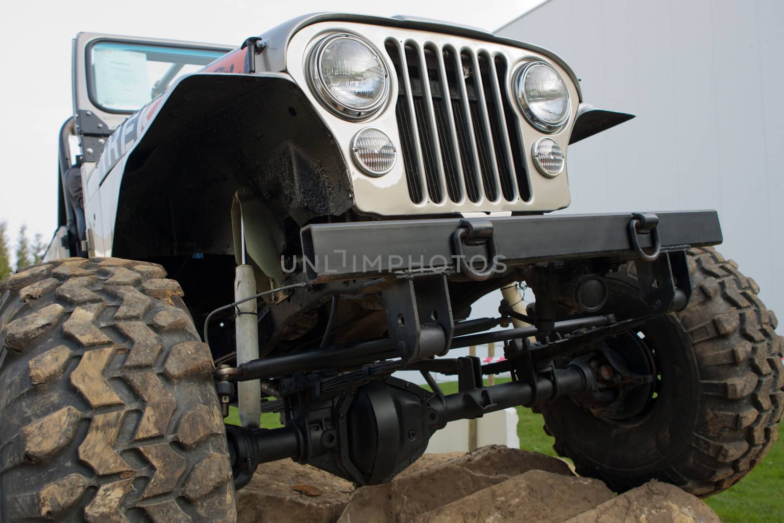 Front end, headlights and grille on a vintage four-wheel drive vehicle.