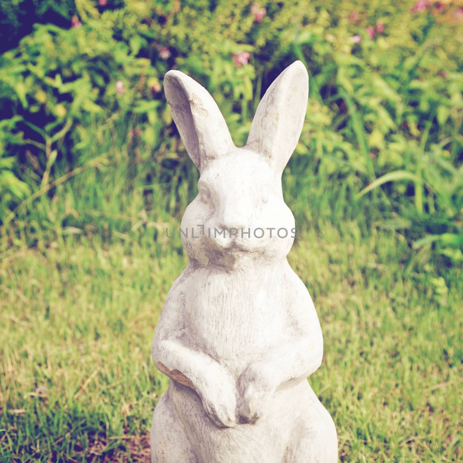 Statue of rabbit in the garden with retro filter effect by nuchylee