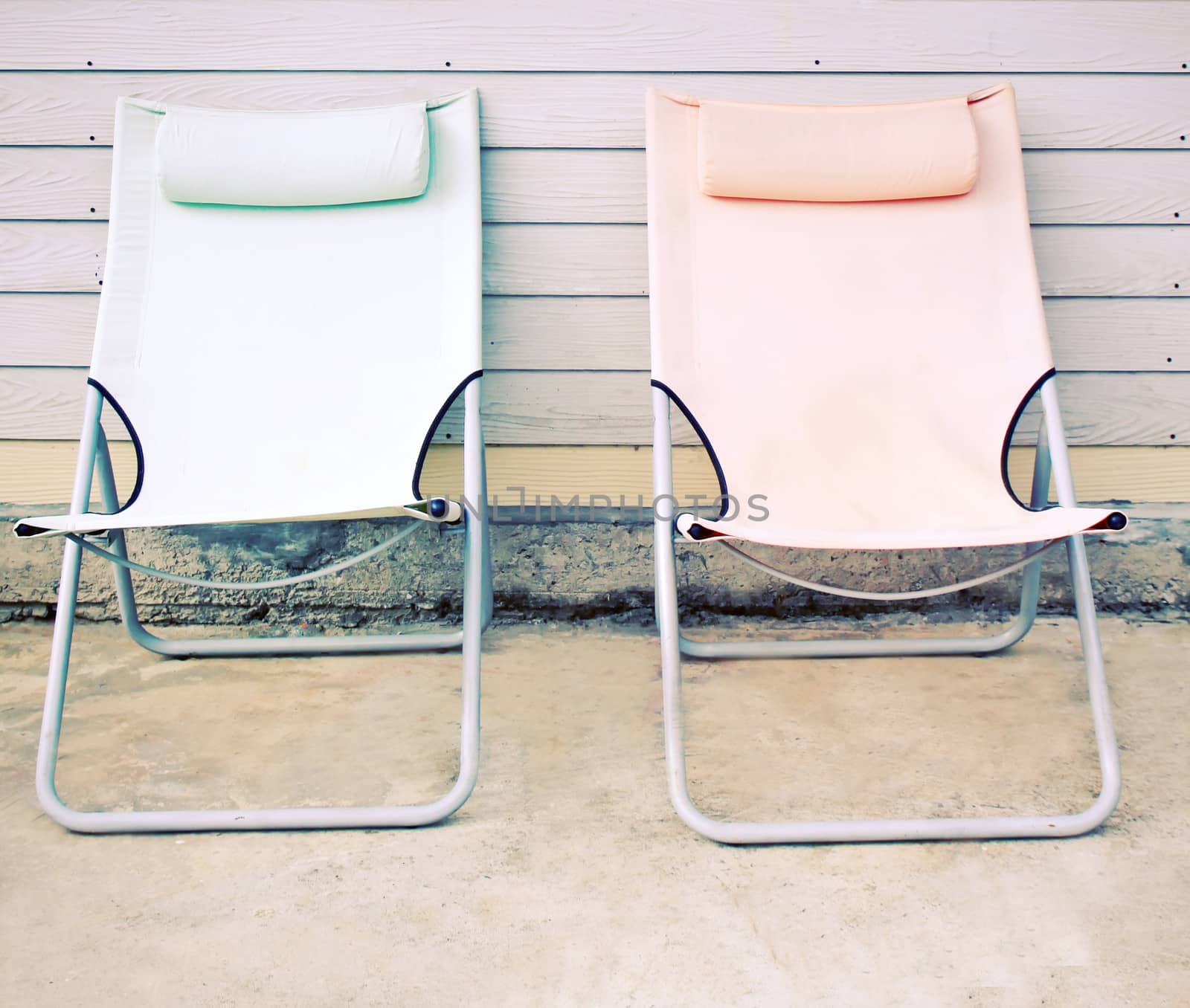 Two beach bench in front of the house with retro filter effect