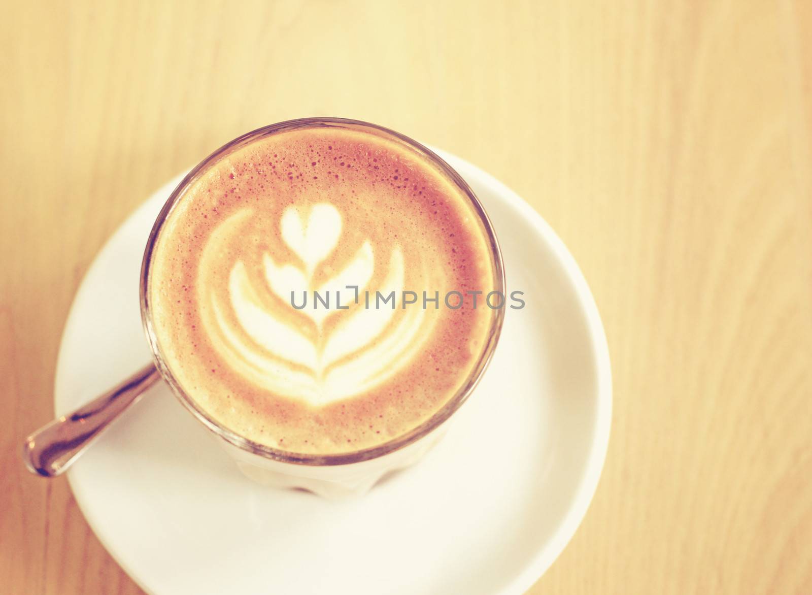 Cup of latte or cappuccino coffee with retro filter effect by nuchylee