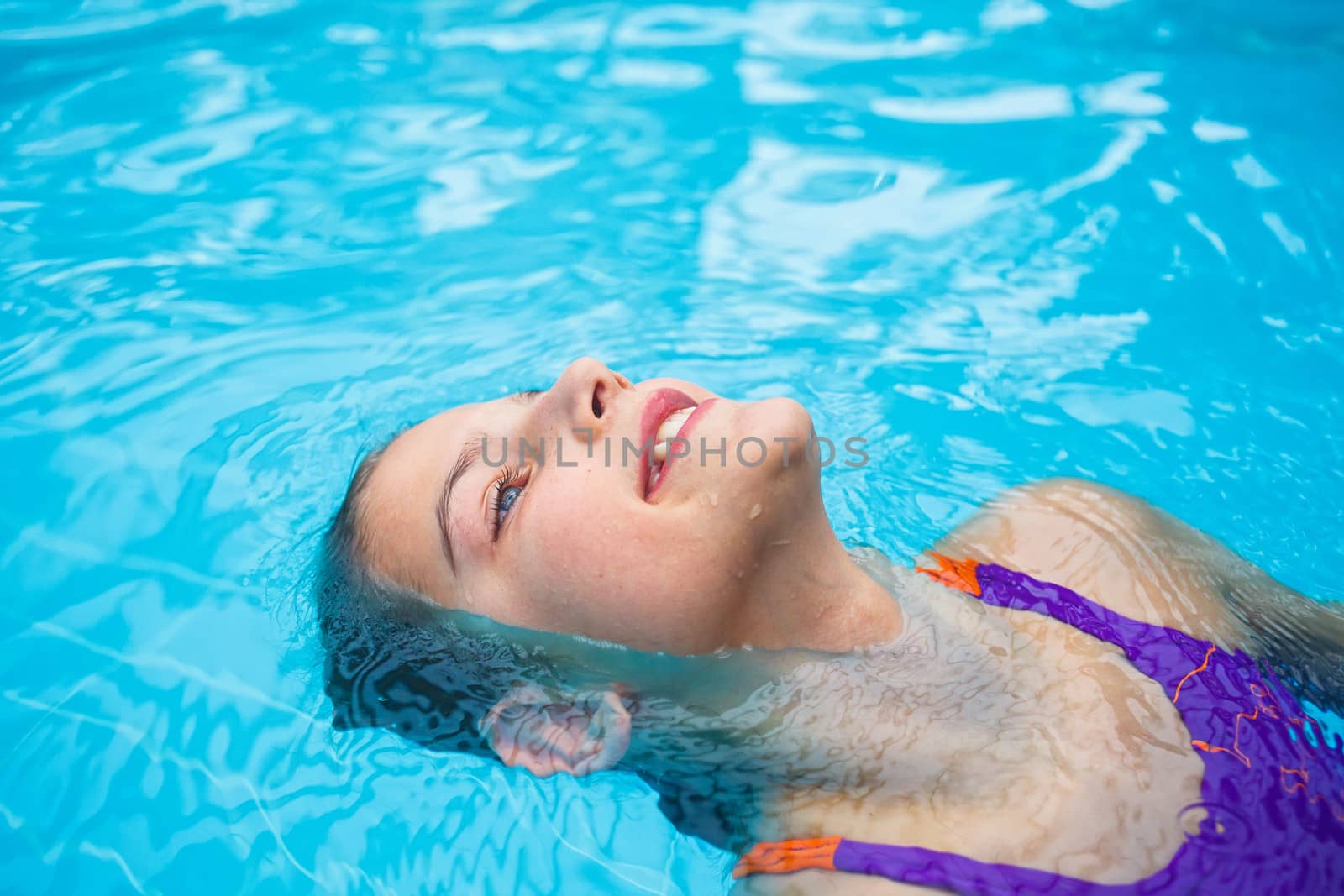 Activities on the pool. Cute girl in swimming pool