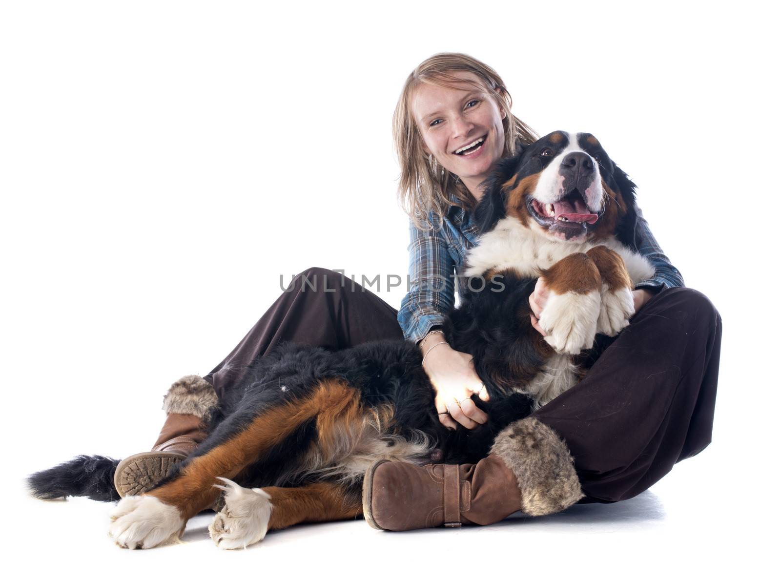 woman and her bernese mountain dog in front of white background