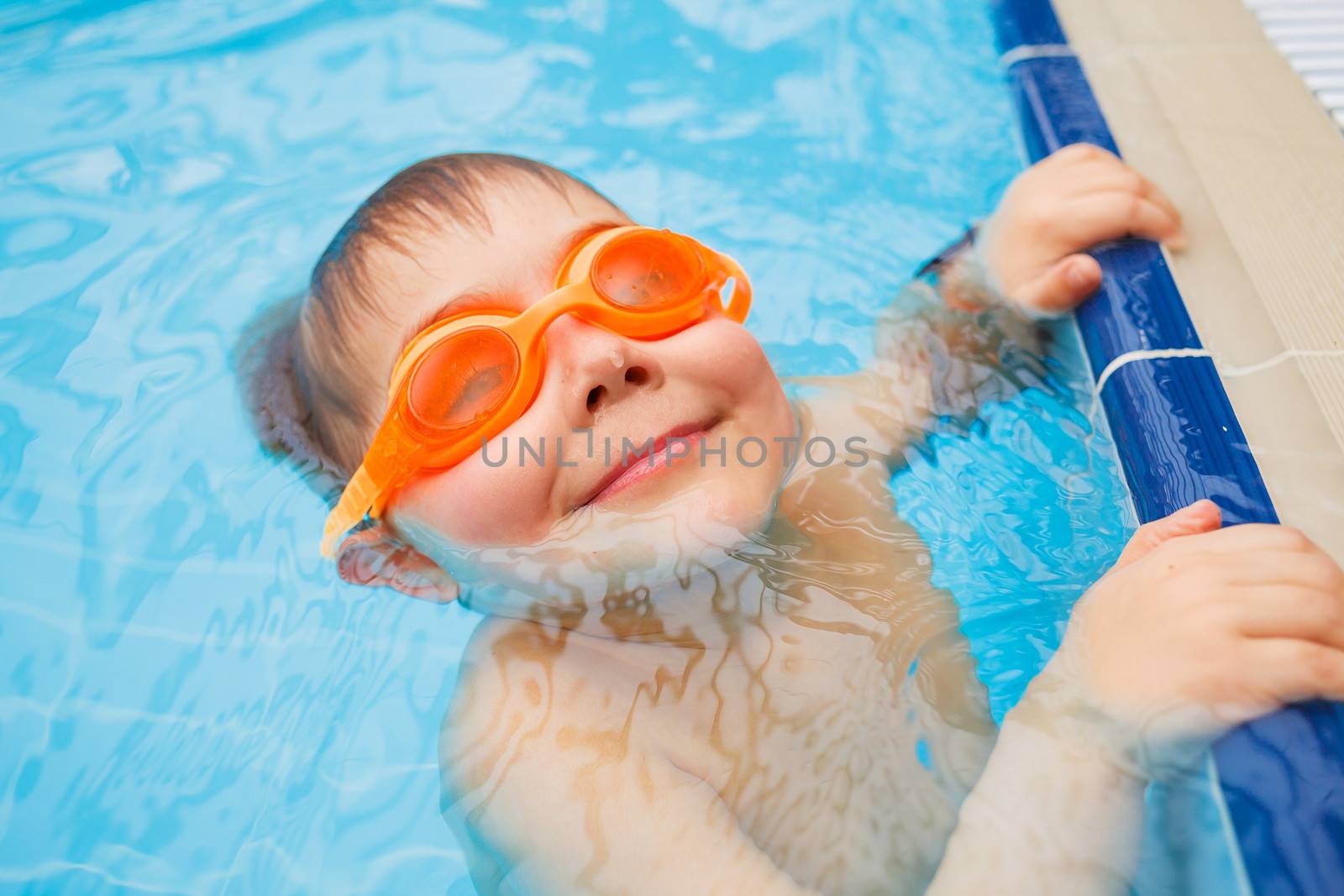 Activities on the pool. Cute boy in swimming pool