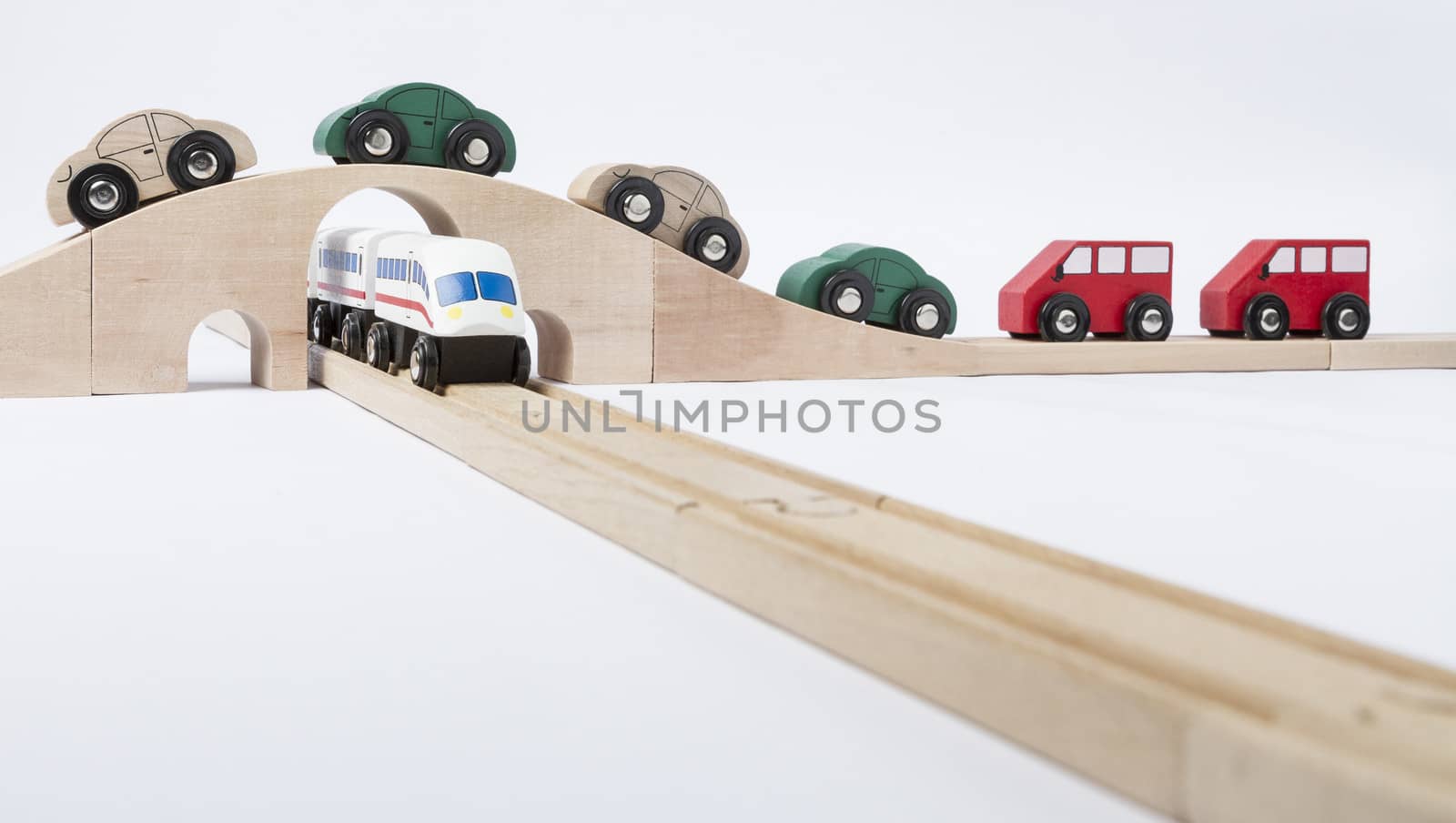 toy traffic with car and train isolated on grey background. horizontal image