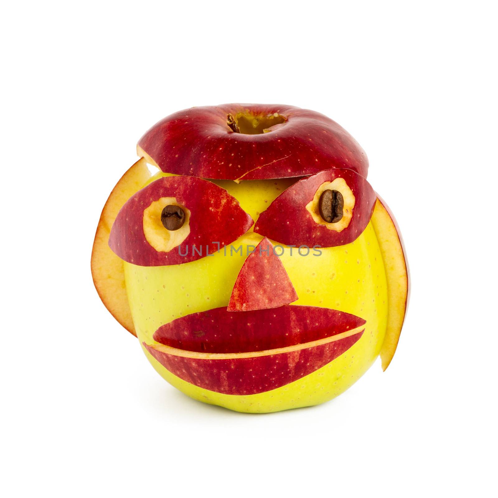 Creative muzzle from two apples of yellow and red color