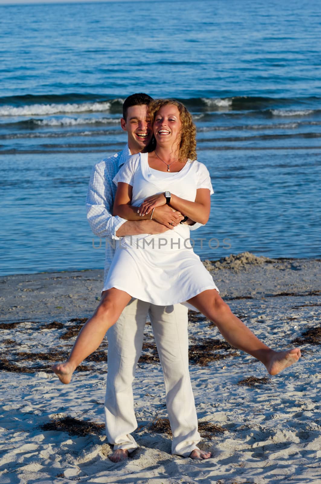 A happy woman and man in love at beach.