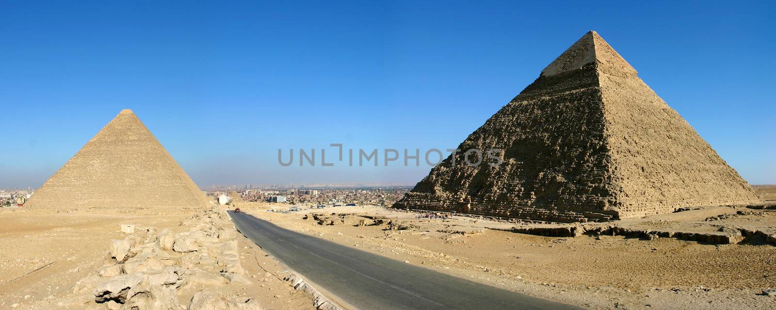 Panorama view of Giza pyramids with a blue sky