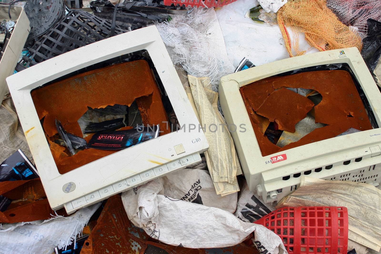 old monitors, computers, copy machines, and other office supplies in the waste