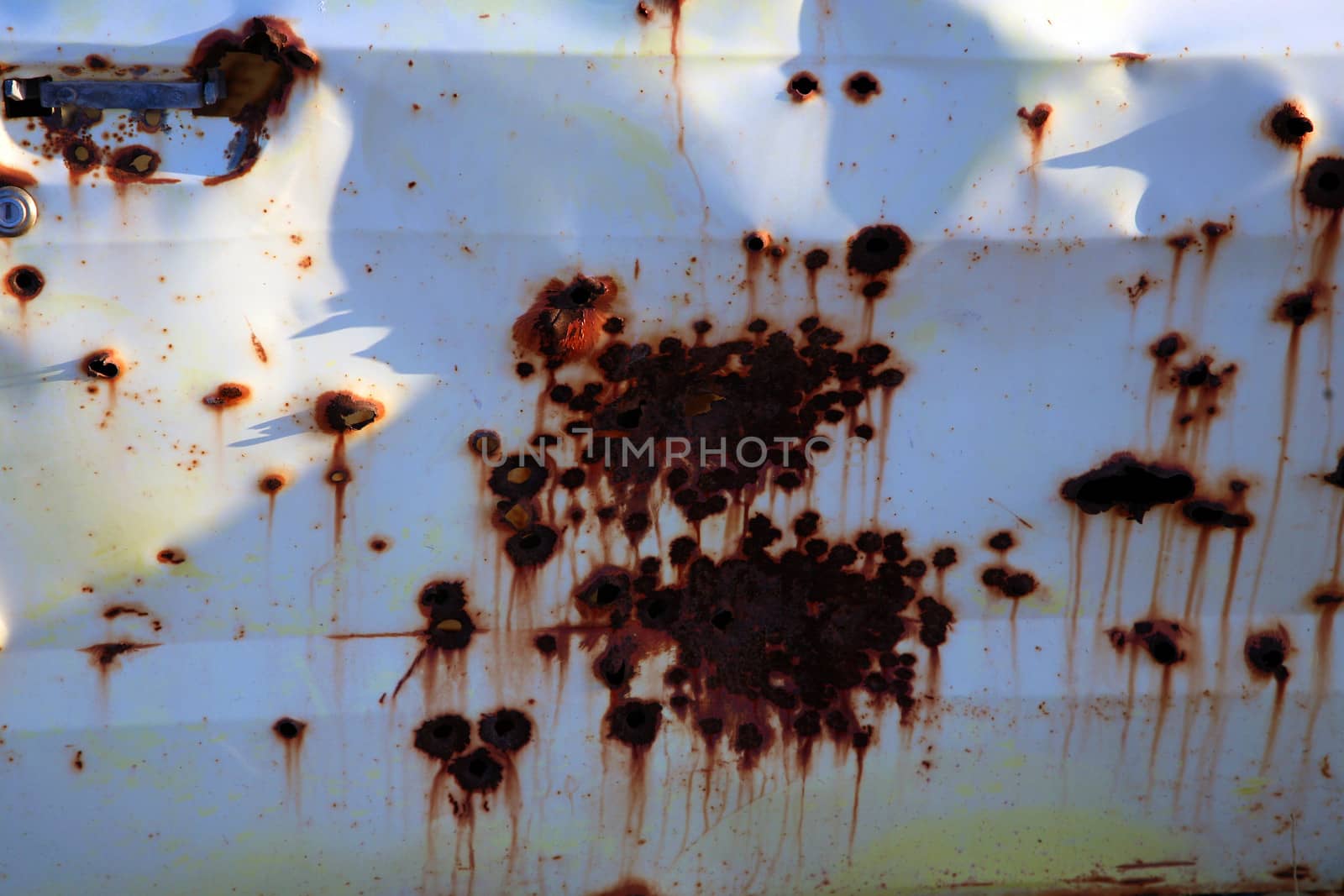 Bullet holes in an old car.