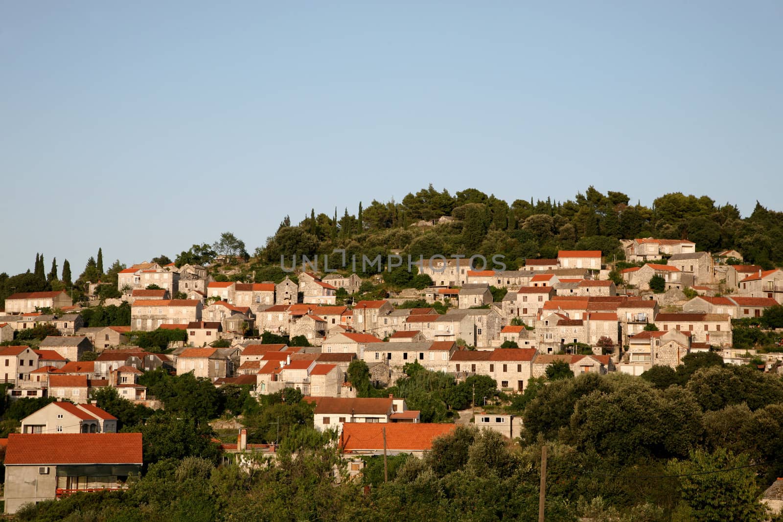 Roofs and tower of the city of Korčula on the island Korčula in Croatia at the sunset time