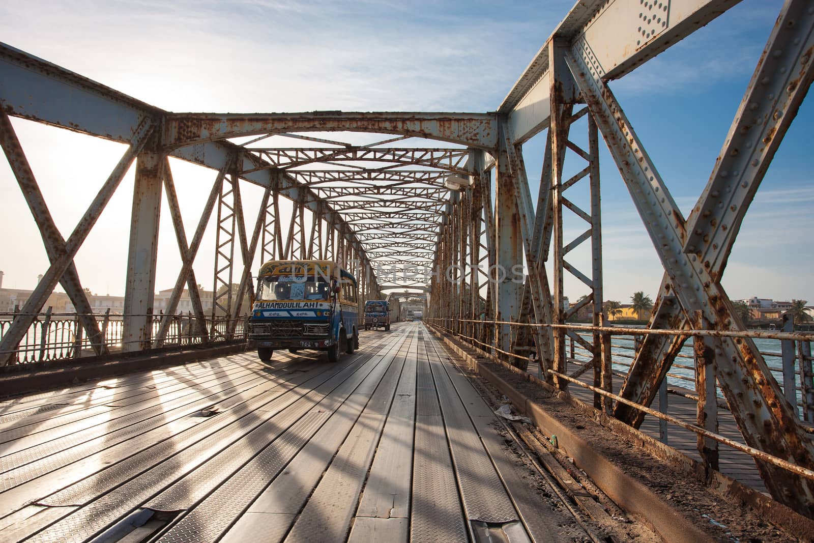 Public bus crossing the Faidherbe Bridge in Saint Louis by watchtheworld