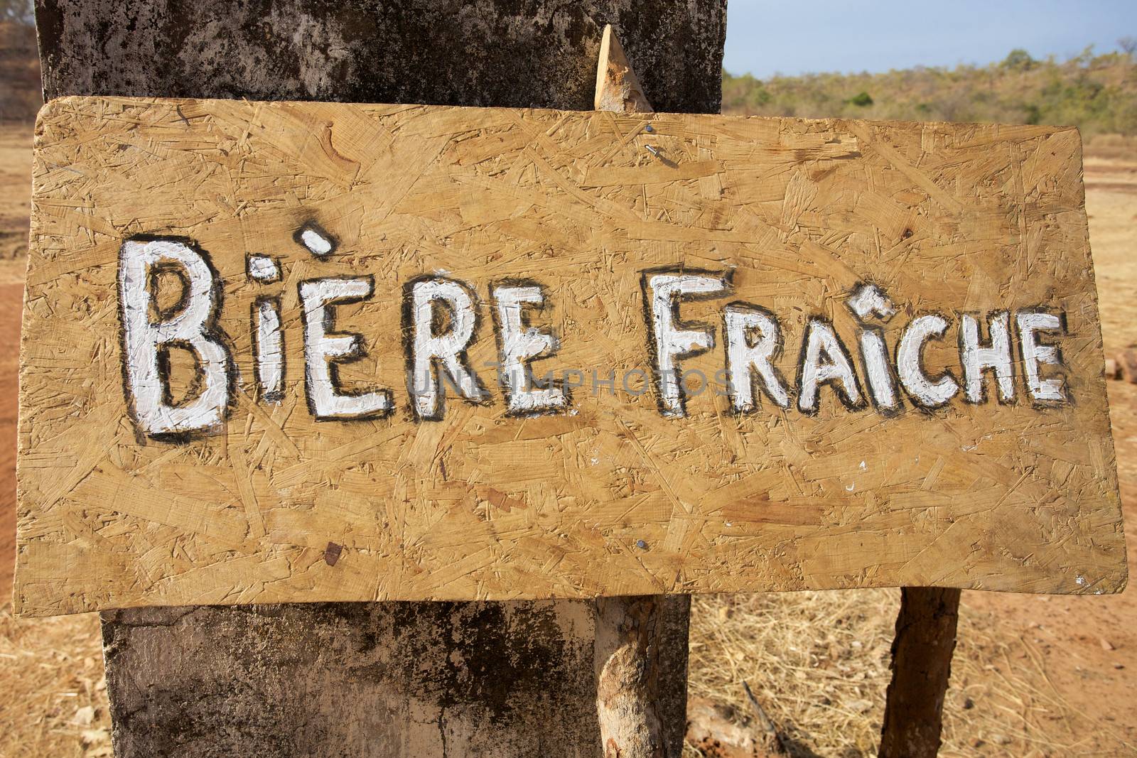 Three with Sign board with Fresh Beer in French at the entrance of the Gouina Community project in Mali