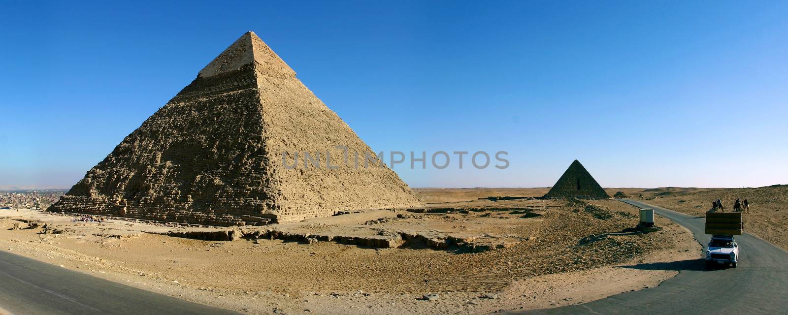 Panorama view of Giza pyramids with a clear blue sky, Egypt.