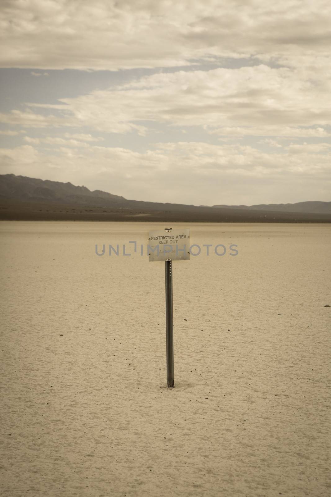 Sign restricted area keep out in the desert of Nevada, retro style image