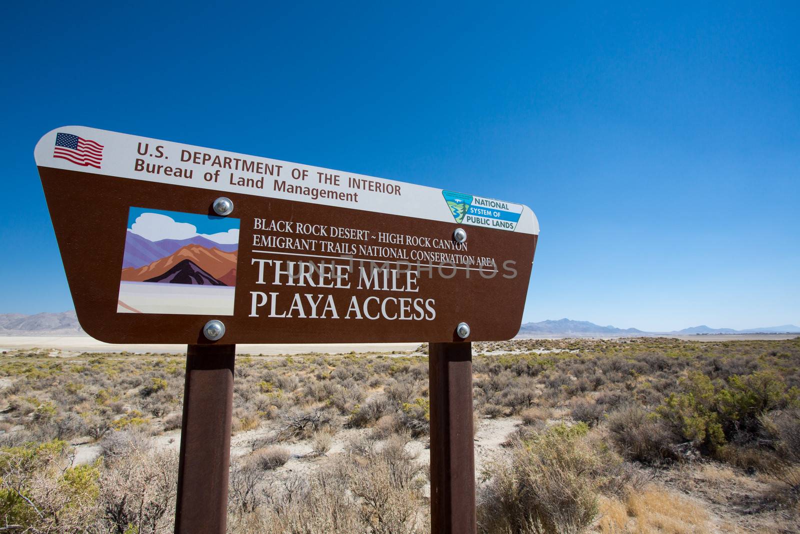 Road sign against a blue sky at the entrance of la Playa in the Black Rock desert in the state of Nevada, location of a famous alternative festival only accessible from August 9 to September 18 only.