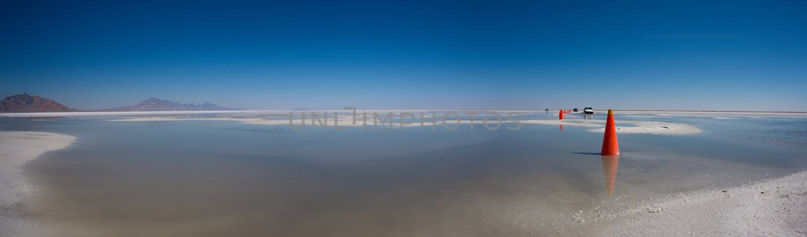 World famous Bonneville Salt Flats outside Salt Lake City Utah with mountains and blue skies. Detail of the salt on the ground