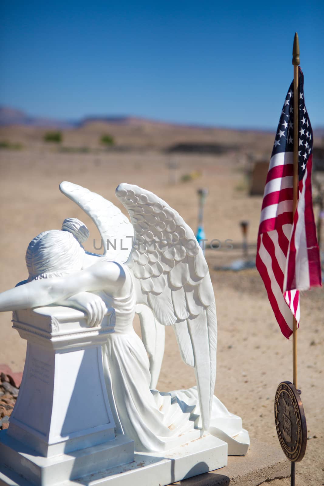 Country cemetery with American Flag and legion medal with tombstones in the background