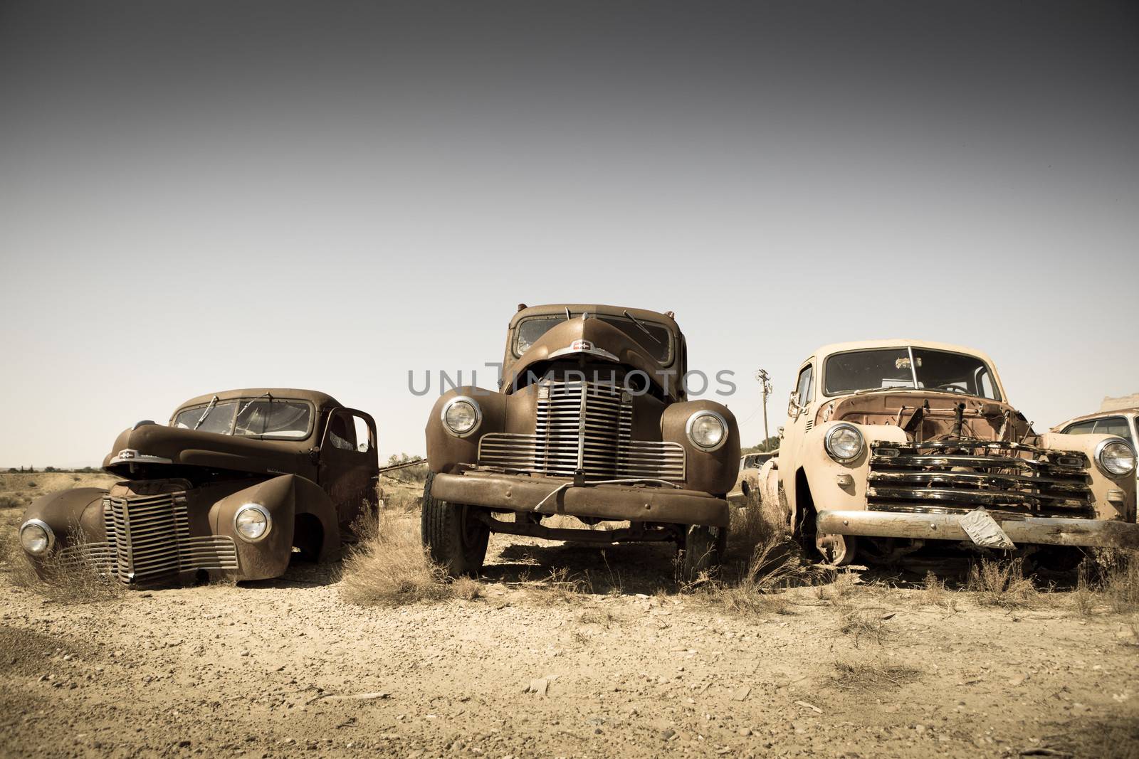 Abandoned vintage cars in the countryside by watchtheworld