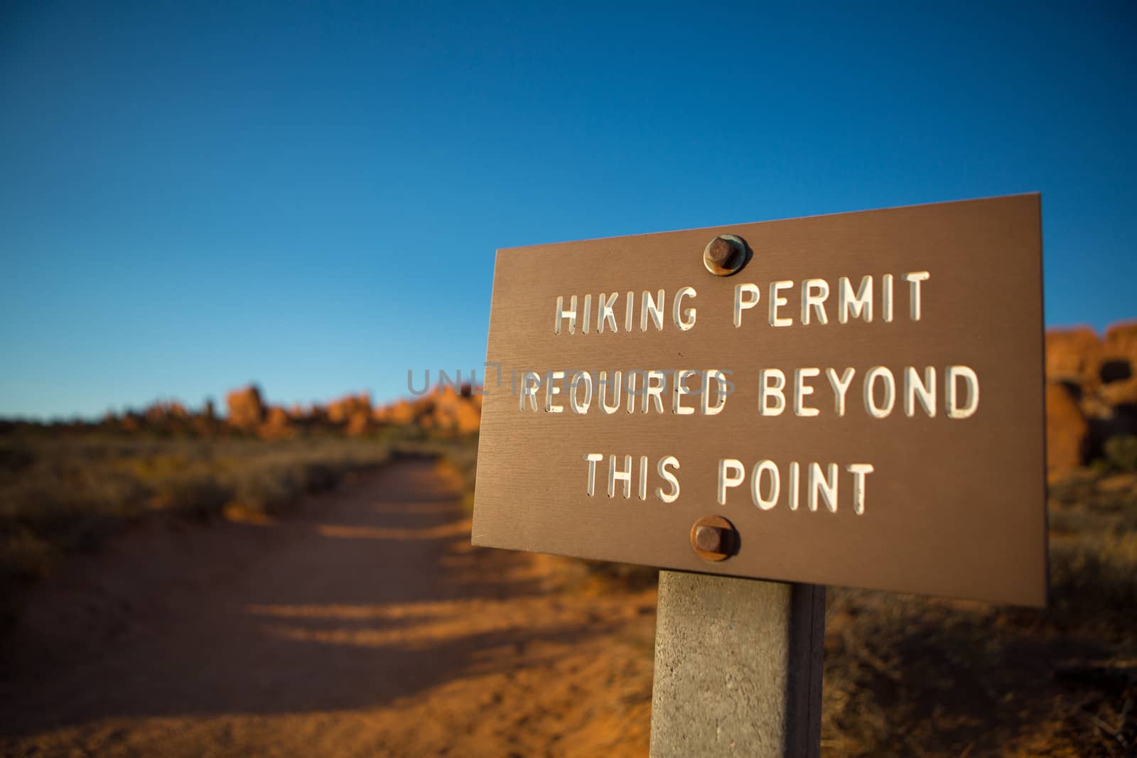 Trail Sign in Arches National Park against a blue sky late afternoon, Utah