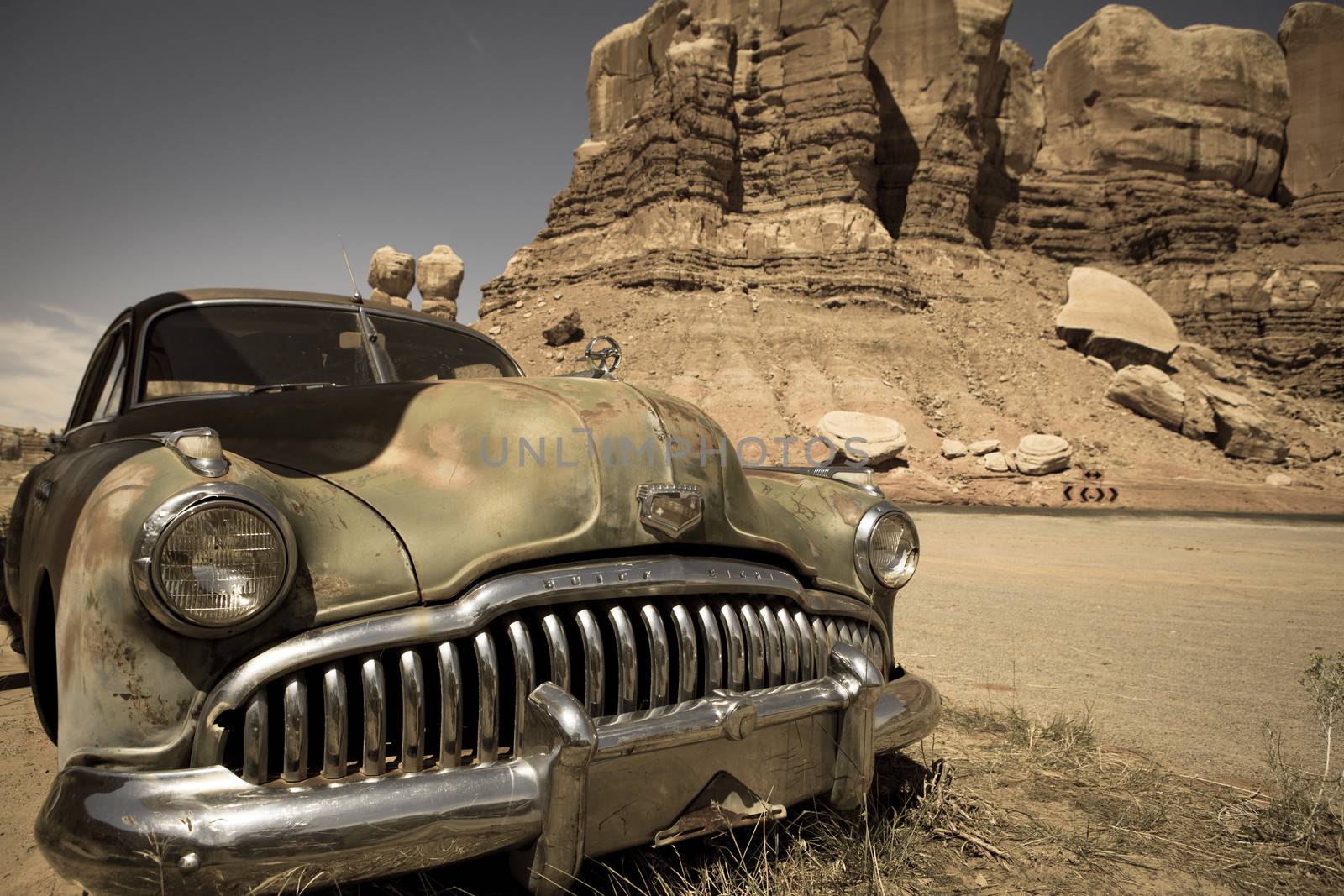 Old abandoned car at the Twin rocks in the Utah, toned image