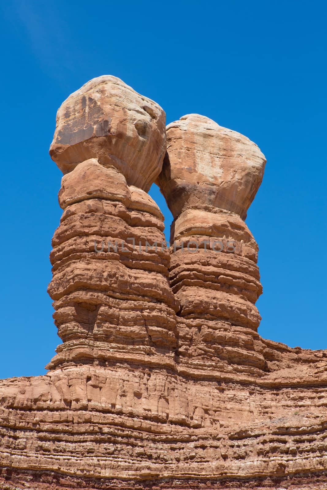 Navajo Twin rocks at the Mexican Hat - rock formation in Southeastern Utah, close to Monument Valley against a blue sky