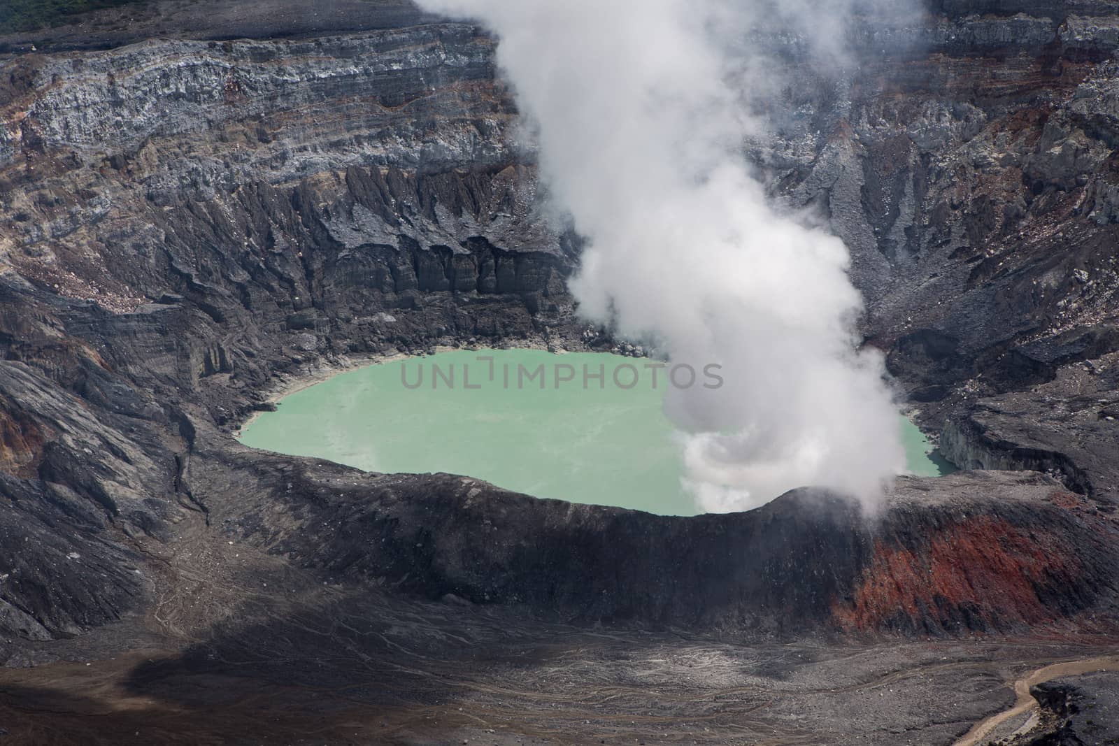 Fumarole smoke over the Poas Volcano in Costa Rica in 2012. Detail of the acid water crater with turquoise colors.