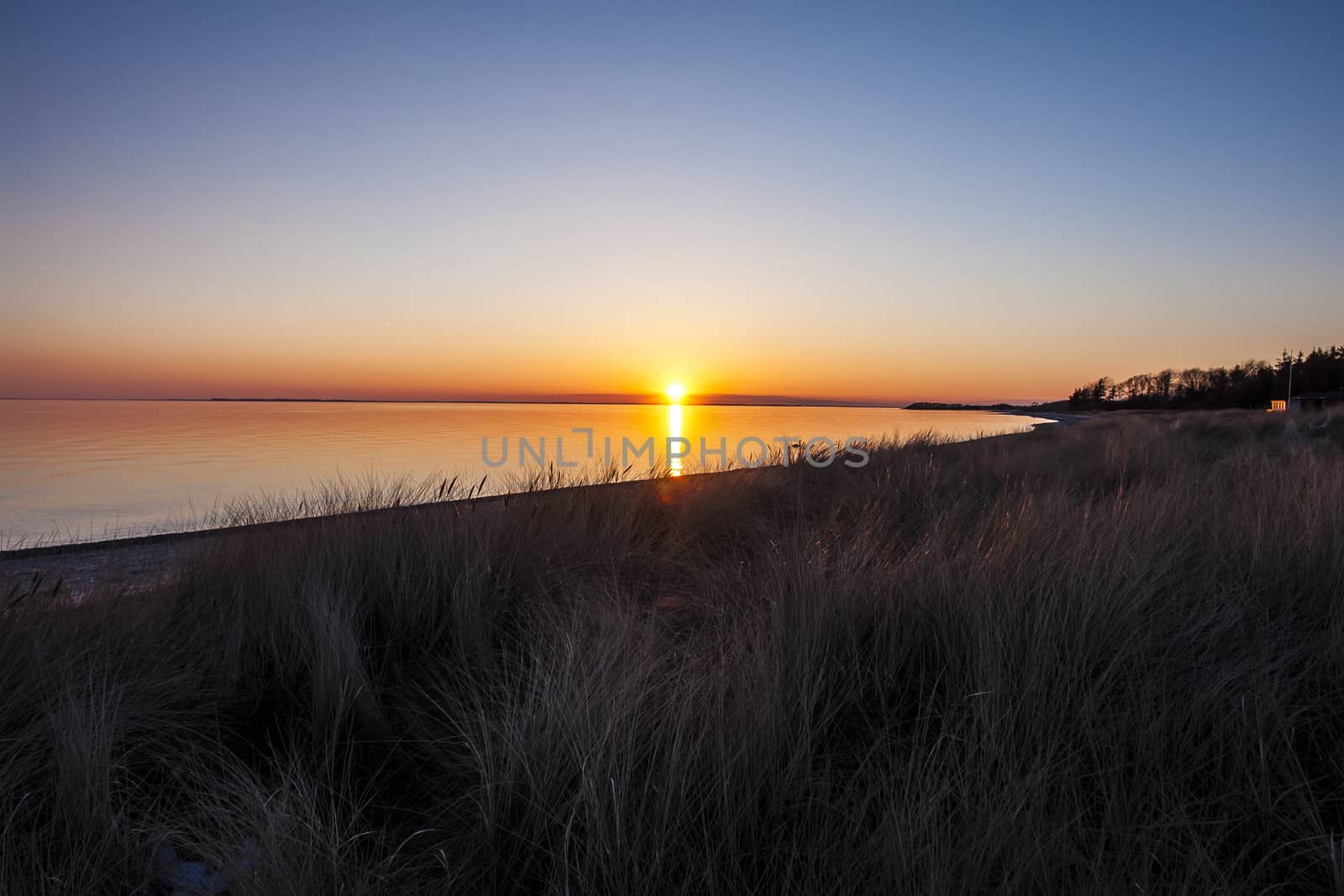 Beautiful sunset above the sea in a lovely beach bay