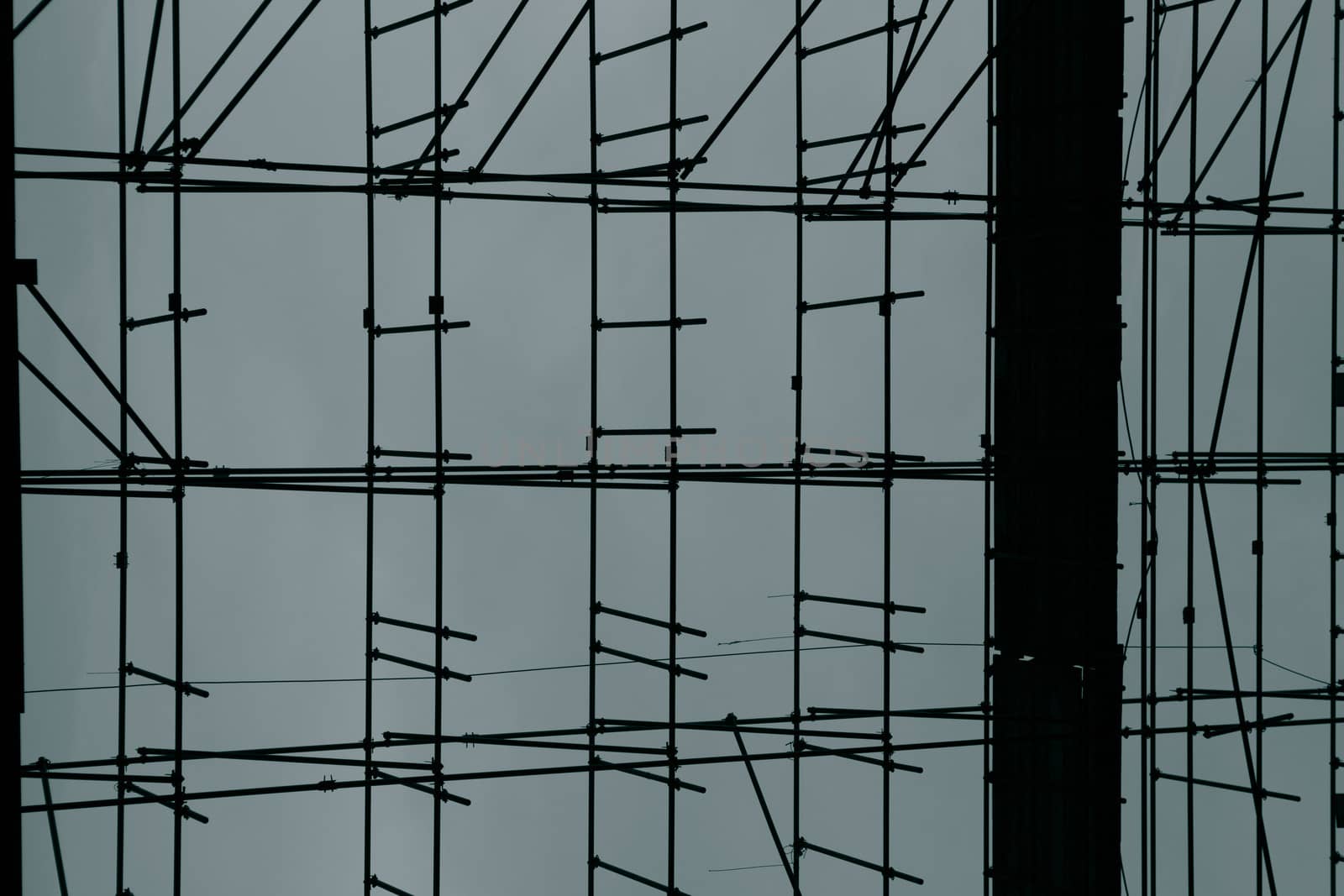 Close up of scaffolding on a construction site with blue backgro by watchtheworld