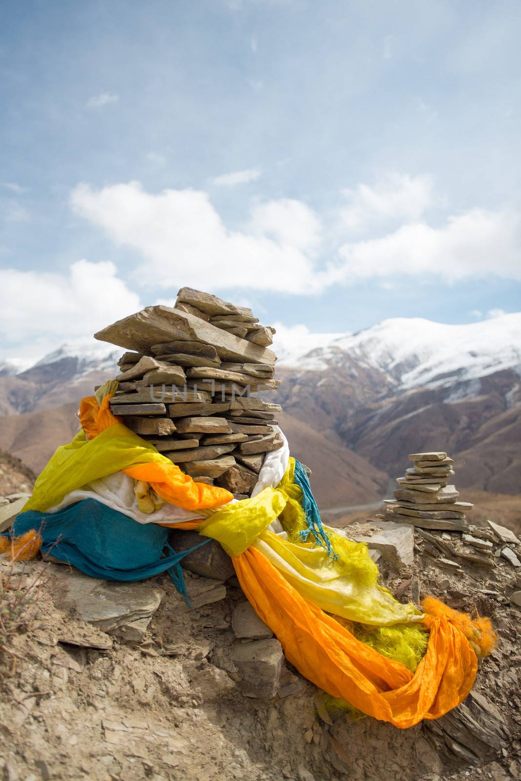 Religious stones with colorful drapes .The road of Friendship in Tibet - Going to Kathmandu