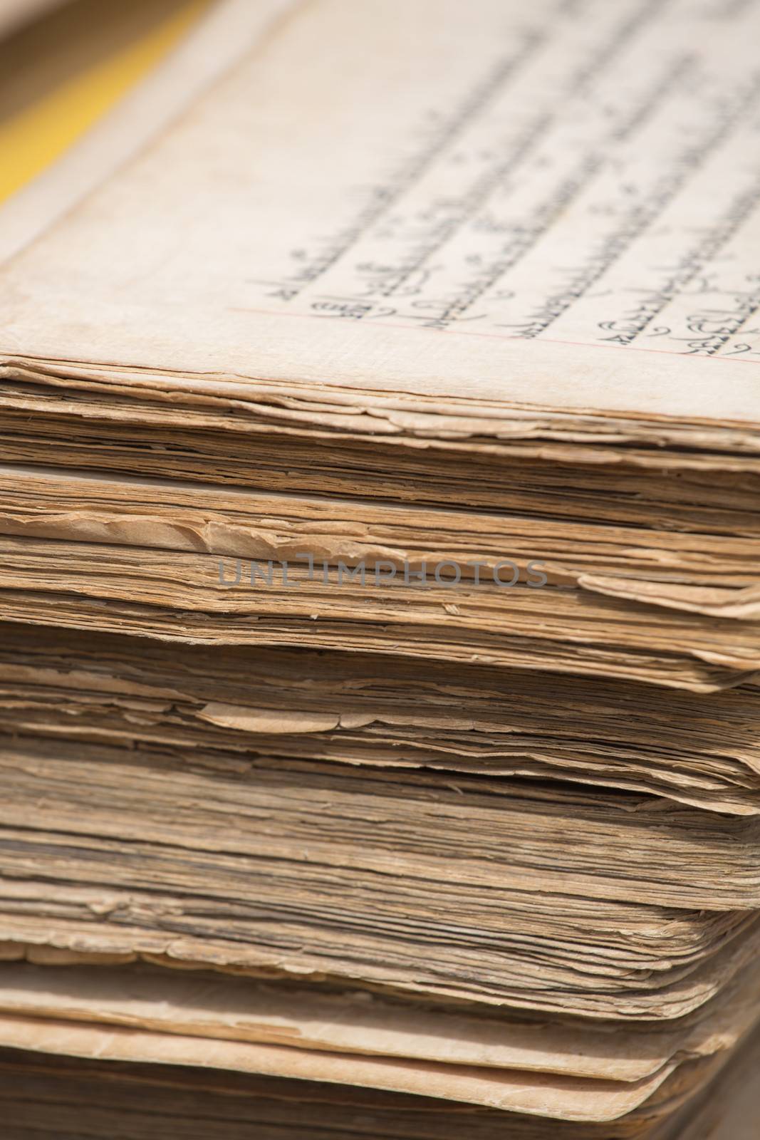 Stack of old Tibetan manuscripts by watchtheworld