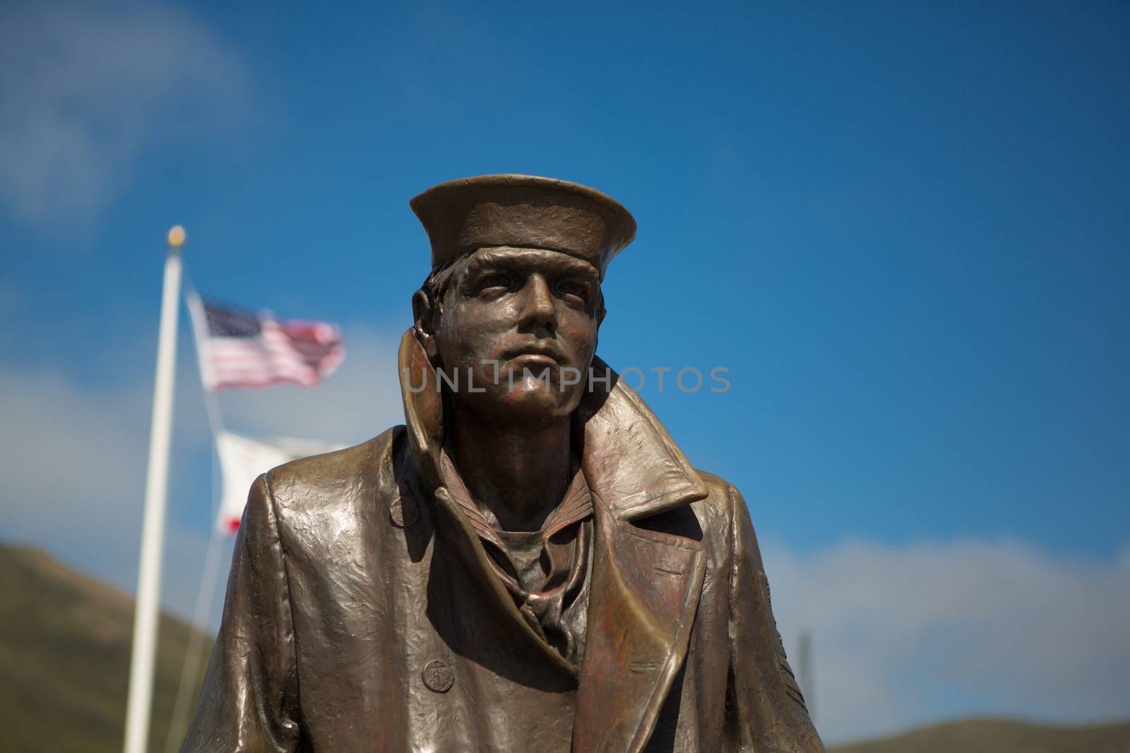 Statue the Sailor and the flags of the United States at the Gold by watchtheworld
