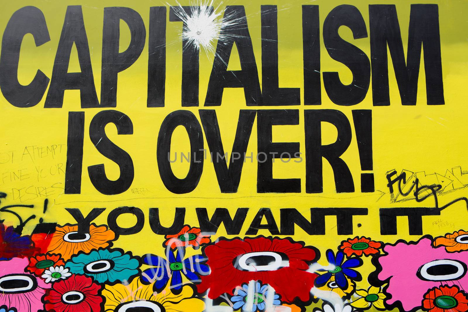 Message on a wall saying capitalism is over, you want it ? by watchtheworld