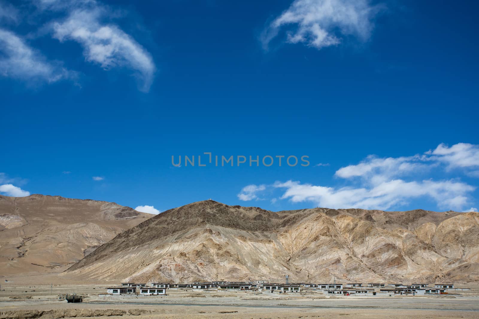 Typical Old Tibetan Village and the mountain behind by watchtheworld