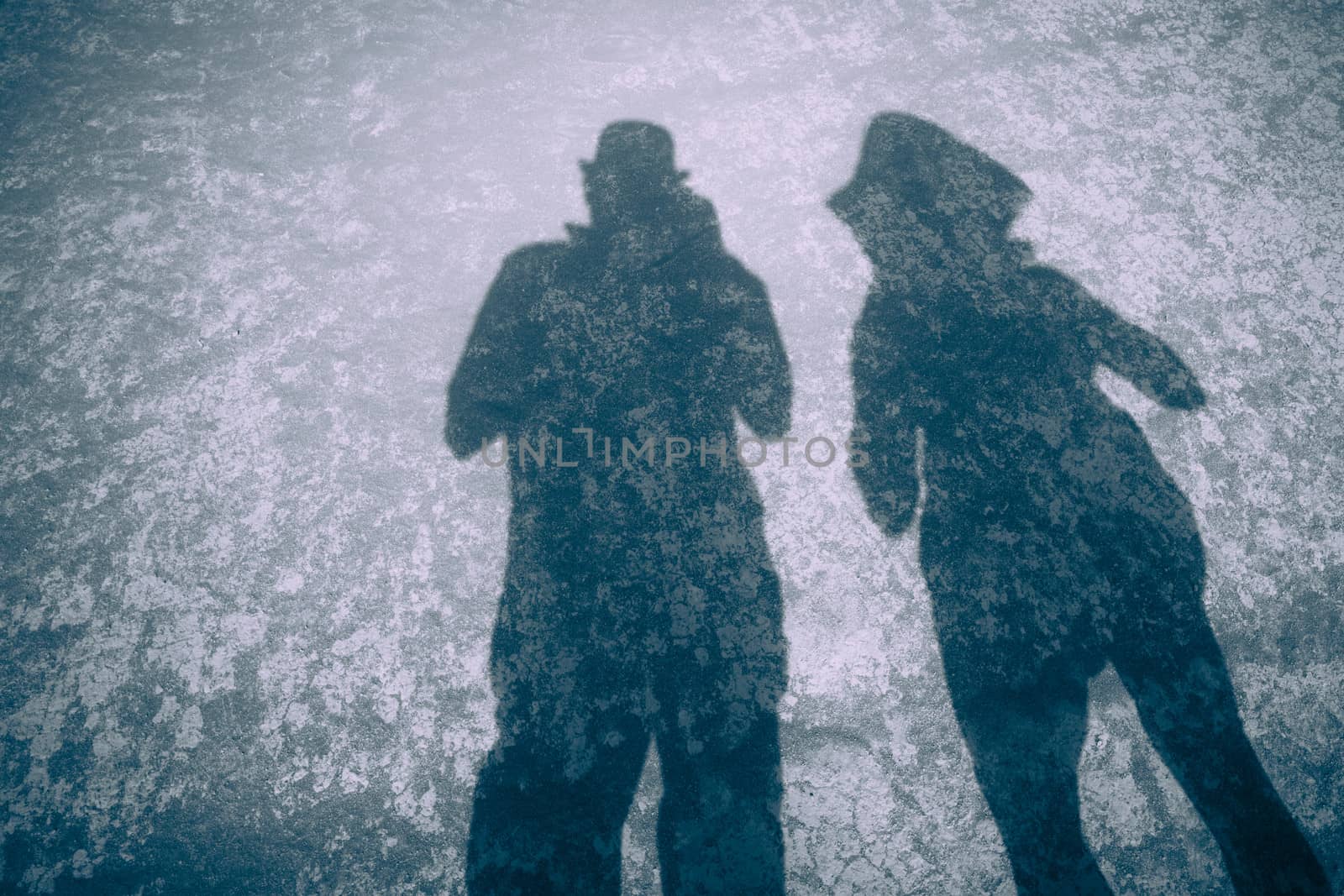 Blue toned colours silhouettes or shadows of a couple on the flat sand desert in Nevada