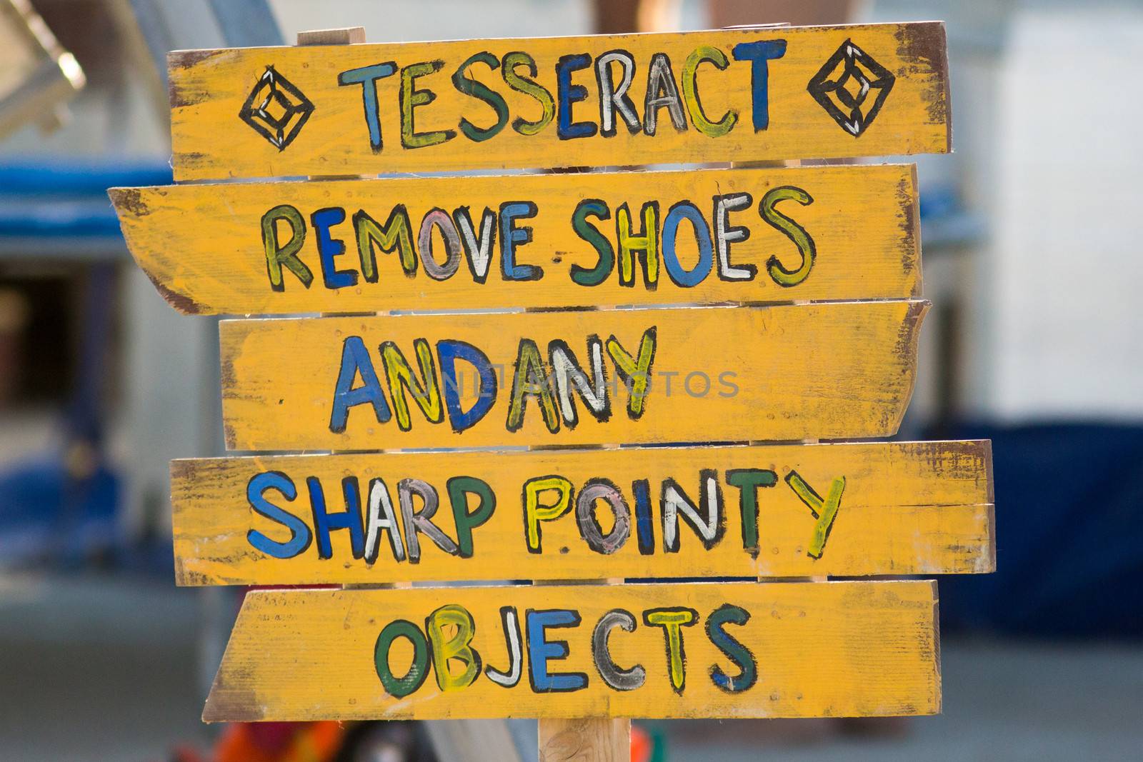 Yellow wood sign to remove shoes by watchtheworld