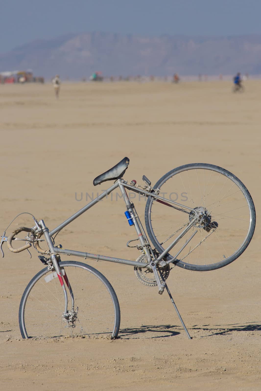 Gray bicycle with nobody, stuck in the sand of the Black Rock desert, Nevada