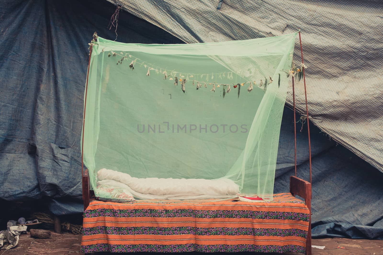Outdoor bed with a green mosquito net in Bhaktapur, Nepal