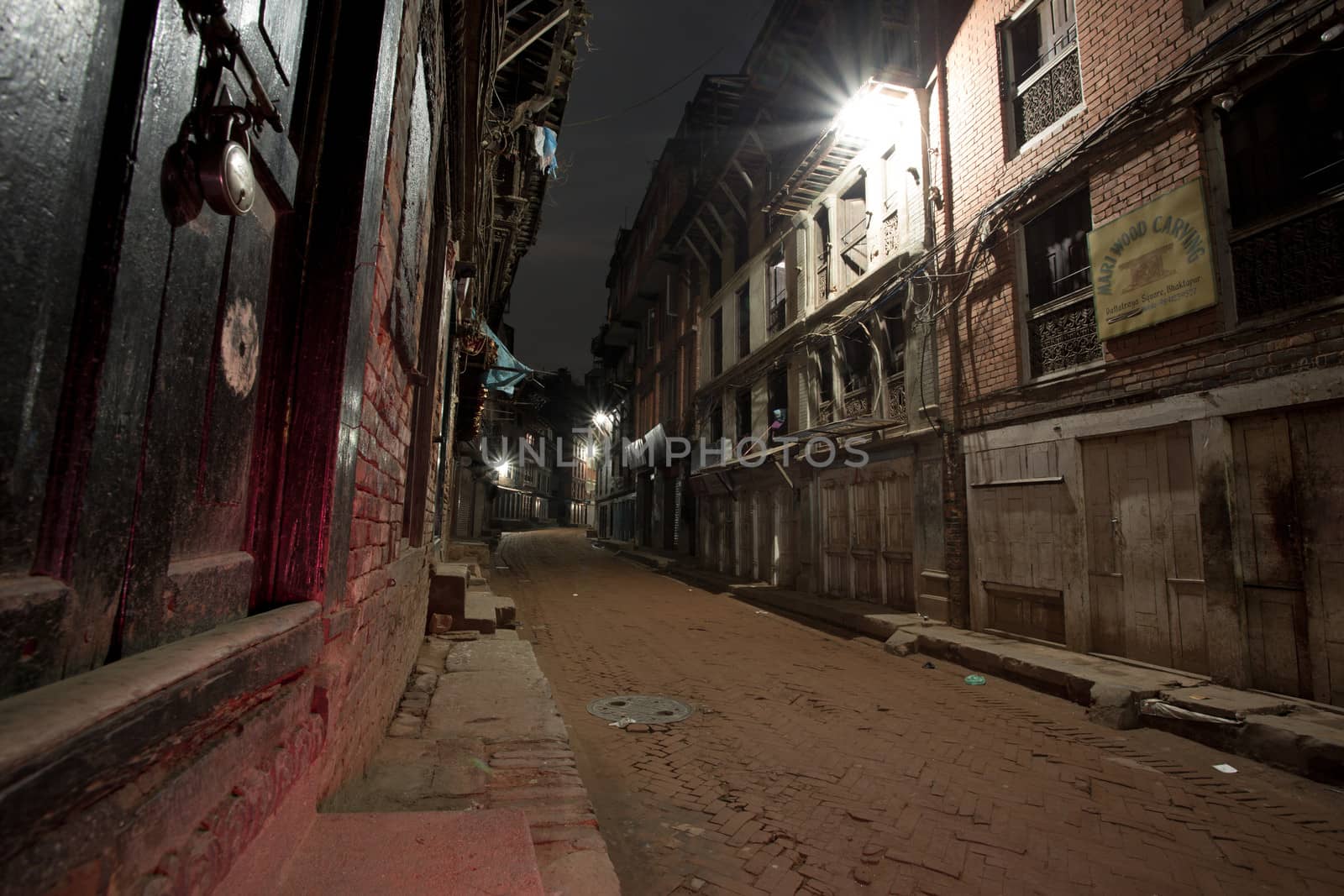 Empty street at night in the old city of Bhaktapur. The old city is a protected UNESCO Heritage site. Long time exposure photo.