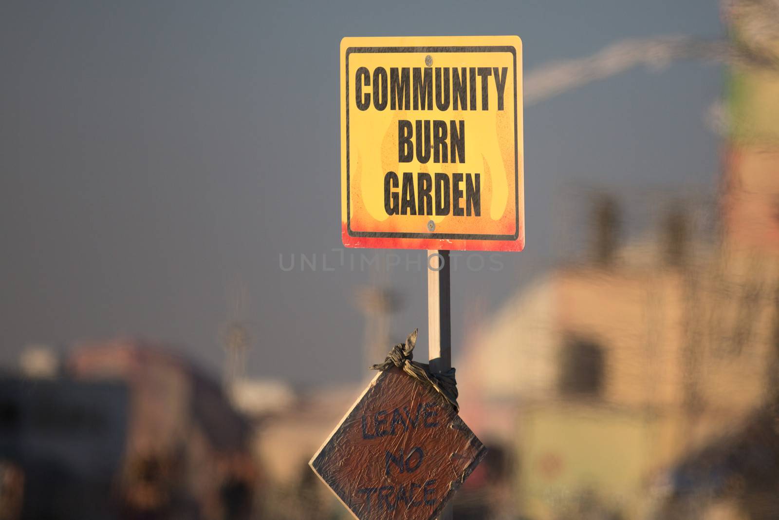 Sign board at Burning Man inviting people to burn their trash and leave no trace when they leave the campsite.