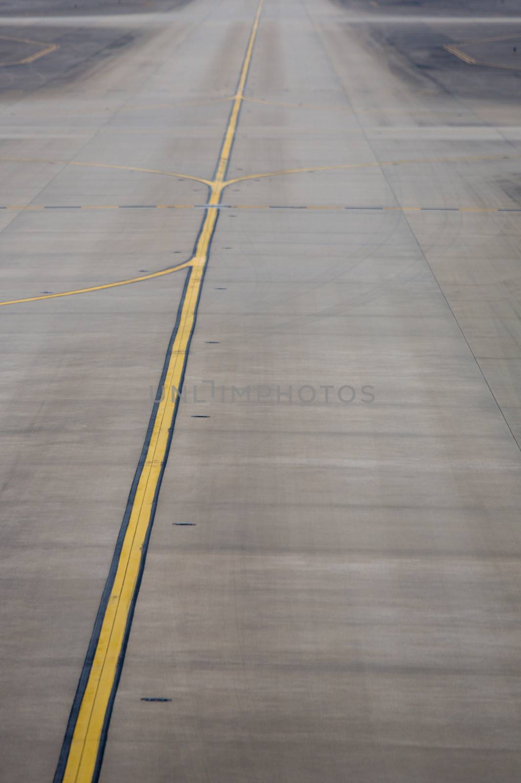 Yellow line on the plane runway in Shanghai Airport by watchtheworld