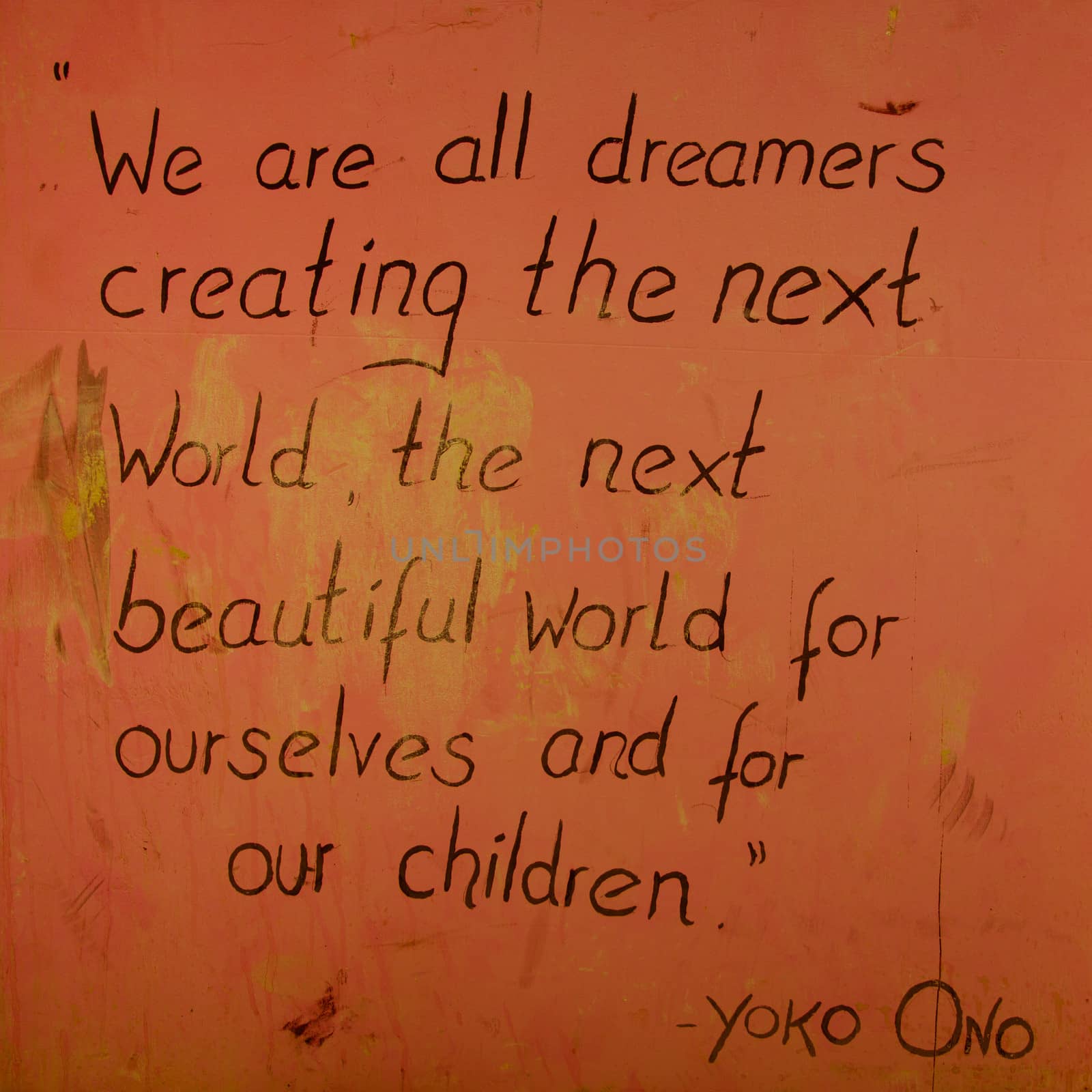 Orange Peace message written on a wall, a famous say from Yoko Ono telling that we have to create the beautiful next world