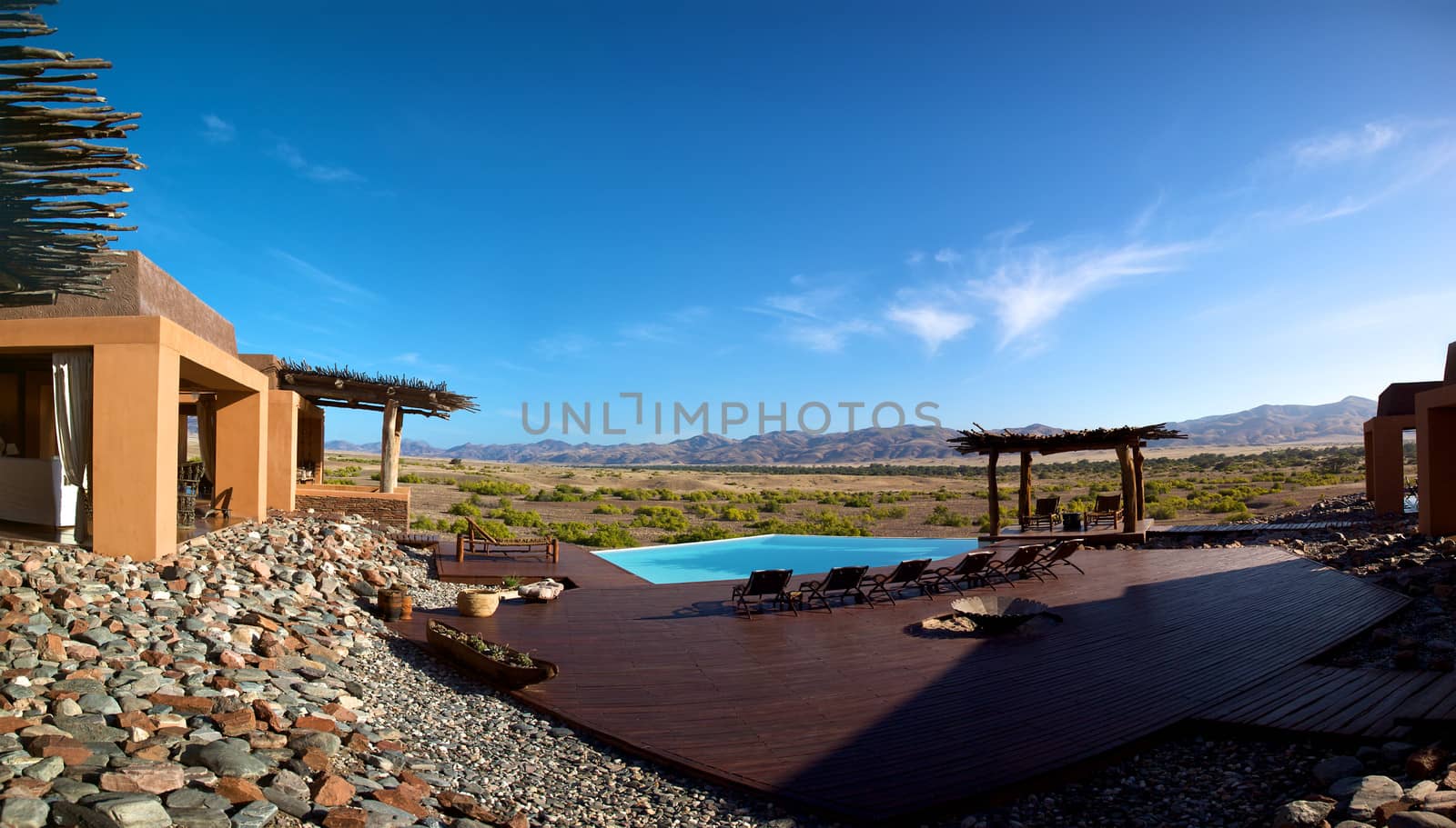 Beautiful swimming pool and mountains in Namibia by watchtheworld