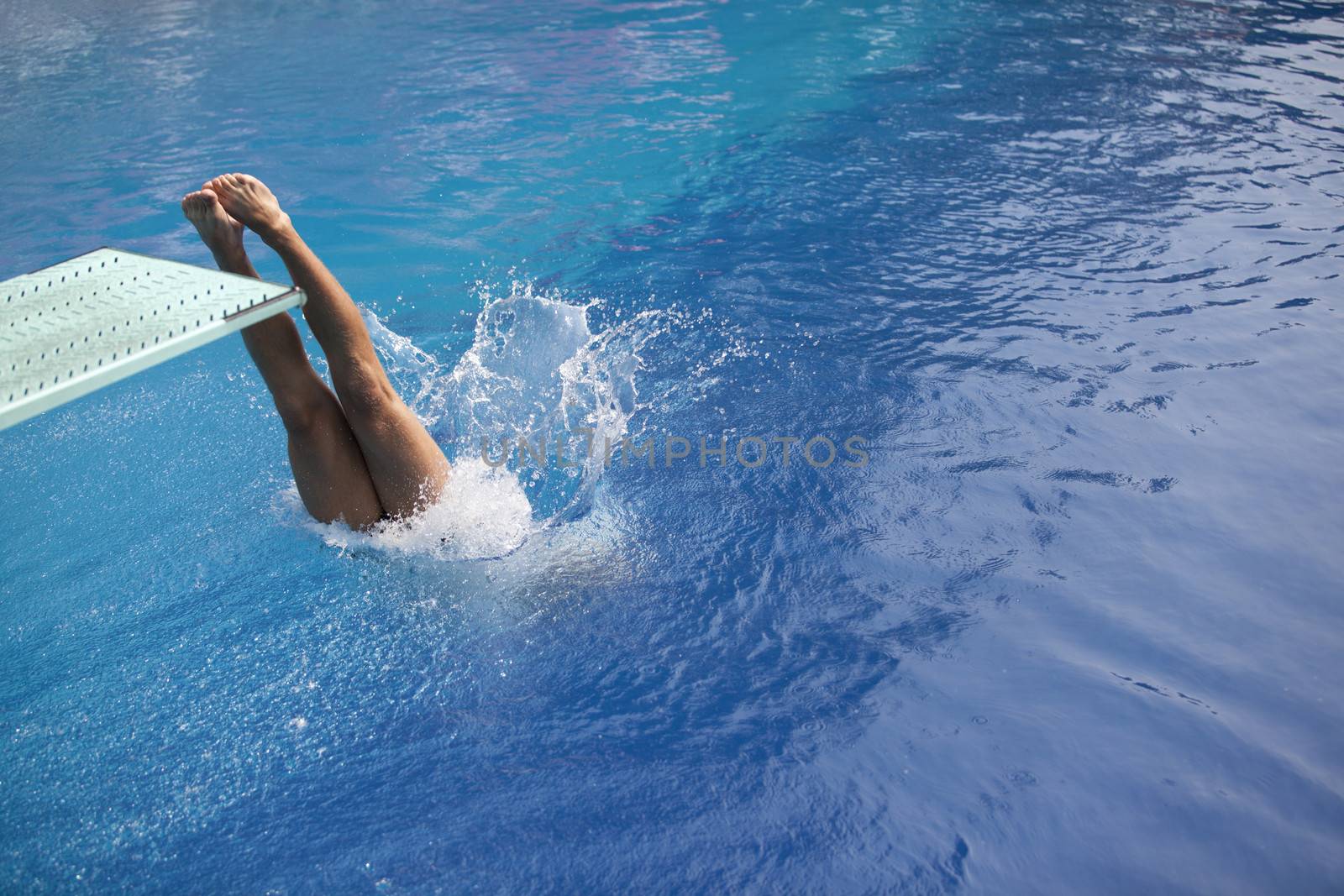 Swimmer diving into a pool