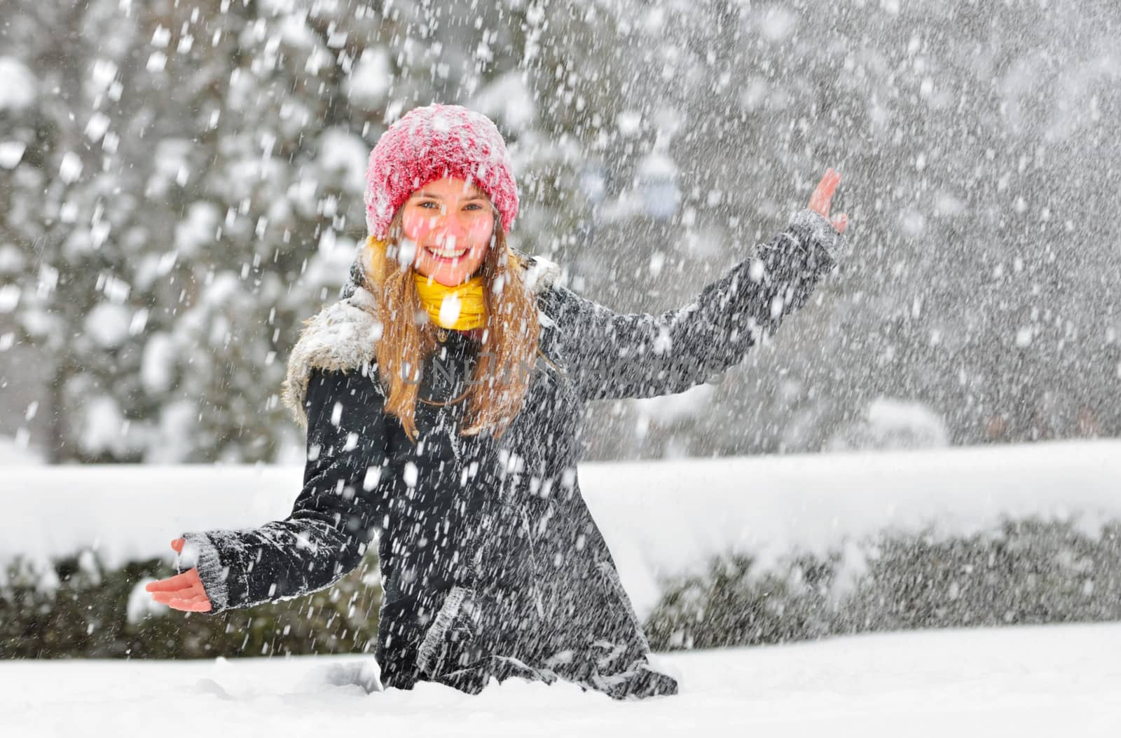 teenager girl play with snow in park