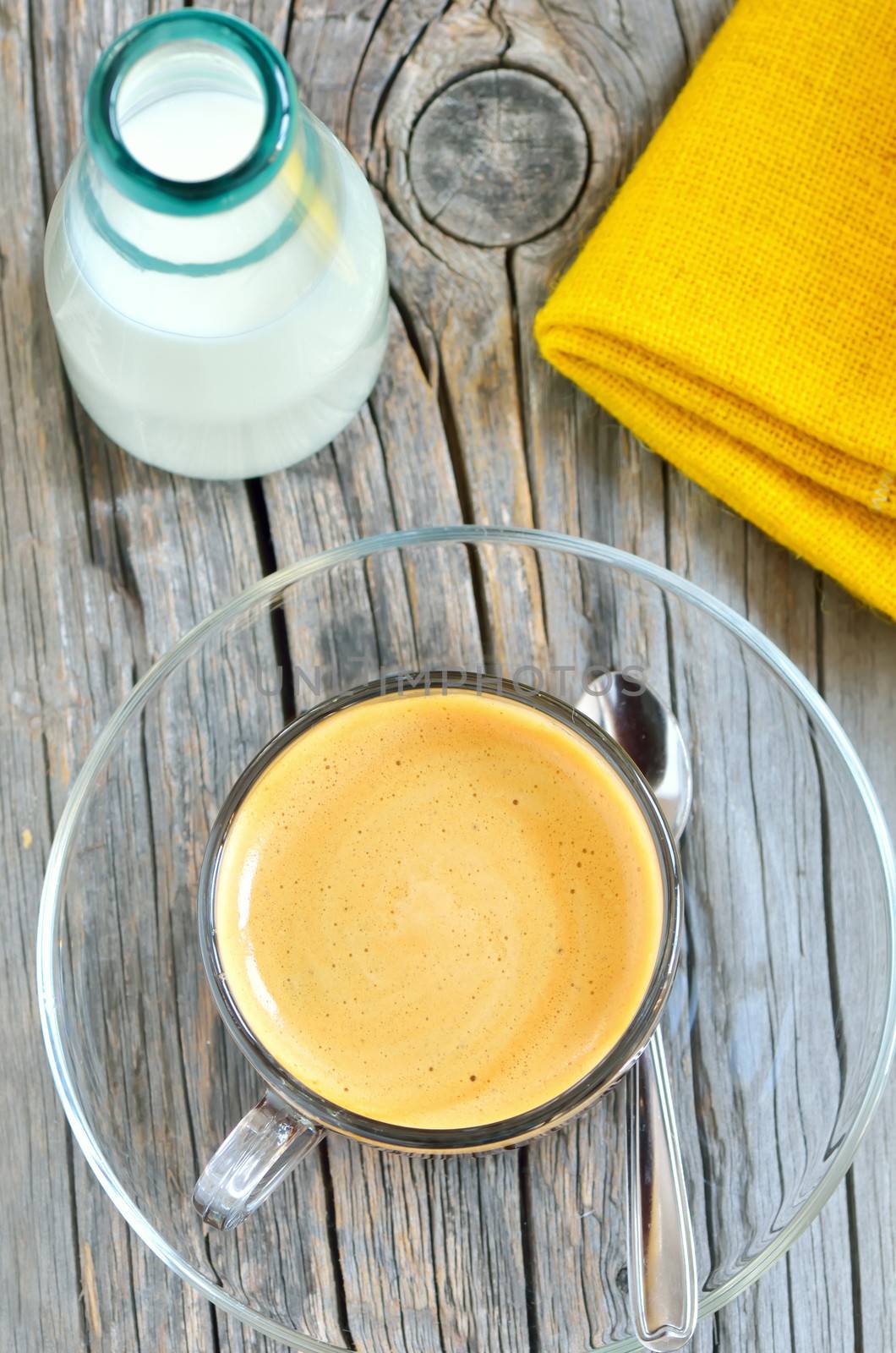 Cup of espresso and milk on old wood