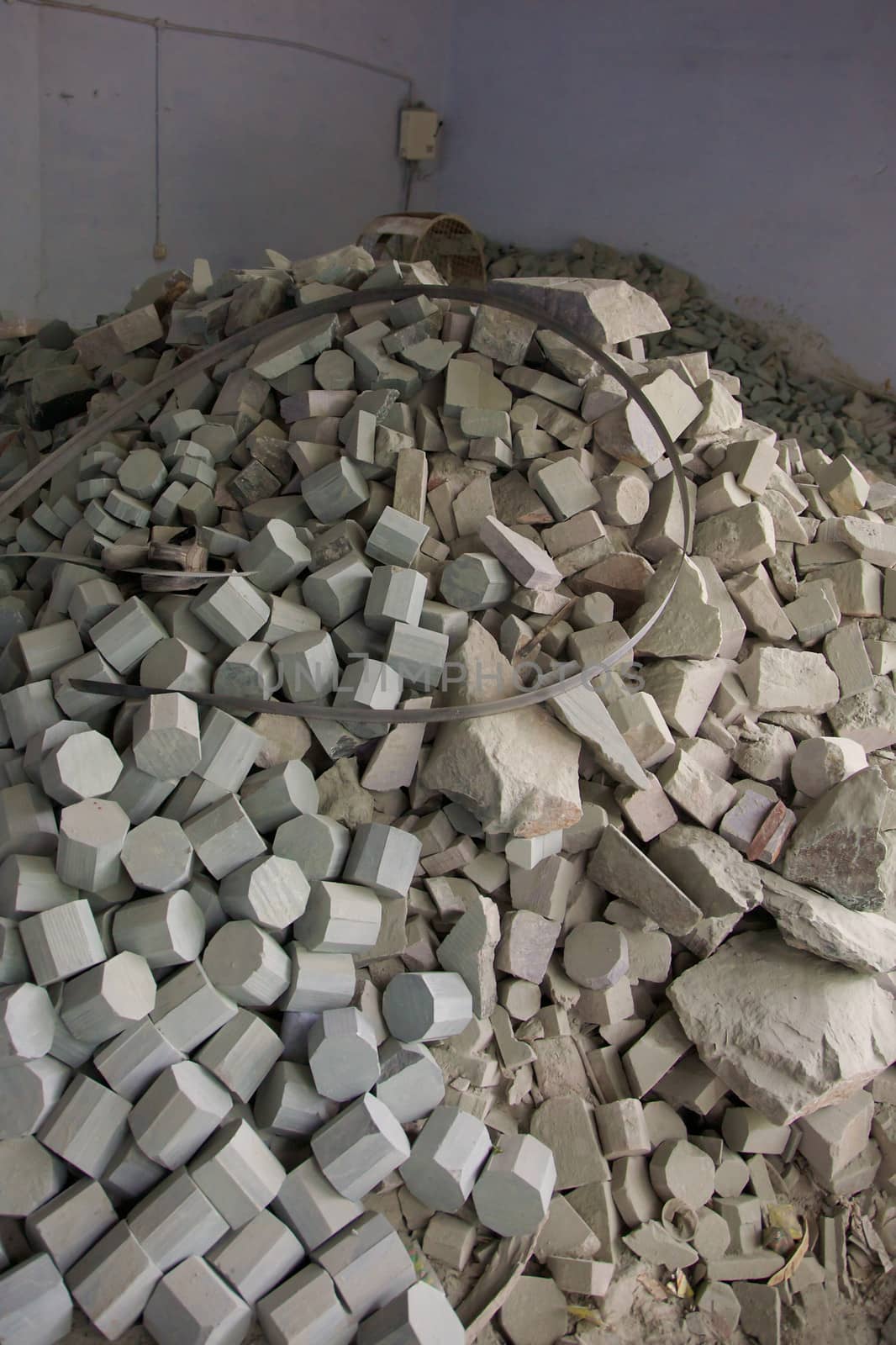 Close-up of a large amount of soap stone pieces all equally cut with a mechanical saw, this is base of any soap stone artifact. Agra, India 2013.